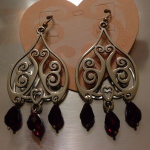 Brighton heart scroll earring with red stones.